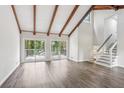 Spacious living area showcasing vaulted ceilings with wood beams and large glass doors leading to an outdoor deck at 6249 Townsend Way, Riverdale, GA 30296