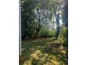 Lush backyard features mature trees and greenery, providing privacy and a serene outdoor space at 1378 Lucile Sw Ave, Atlanta, GA 30310
