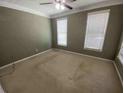 Spacious bedroom with natural light from two windows, neutral walls, and a ceiling fan at 1378 Lucile Sw Ave, Atlanta, GA 30310