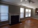 Spacious living room featuring gleaming hardwood floors, a classic fireplace, and lots of natural light at 1378 Lucile Sw Ave, Atlanta, GA 30310