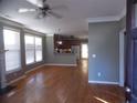 Open-concept living room with hardwood floors flowing into the kitchen area, complemented by bright natural light at 1378 Lucile Sw Ave, Atlanta, GA 30310