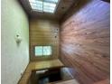 Bedroom featuring wood floors and paneling, with natural light from a large window at 9160 Carr Cir, Covington, GA 30014