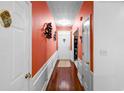 Inviting hallway with hardwood floors, contrasting wall colors and decorative artwork at 2011 Wildcat Lake Ct, Lawrenceville, GA 30043