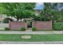 A charming townhome with a brick privacy wall, gate, and lush landscaping at 3163 Neal Ct, Cumming, GA 30041