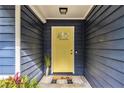 Inviting entrance with a bright yellow door and stylish 'hello' doormat at 195 Ansley Ct, Roswell, GA 30076