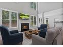 Bright living room with a fireplace, large windows, and open floor plan at 2934 Mill Grove Ter, Dacula, GA 30019