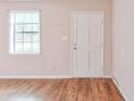 Entryway featuring wood-look flooring, a bright window, and a white door at 3812 Clare Ct, Duluth, GA 30096