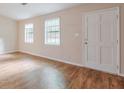 Spacious entry area with wood-look flooring, bright windows, and a white door at 3812 Clare Ct, Duluth, GA 30096