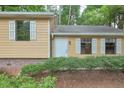 Close up of the home's entrance area shows details like window trim, and fresh landscaping at 3812 Clare Ct, Duluth, GA 30096