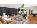 A modern living room featuring a black marble fireplace, hardwood floors, and plenty of natural light at 4070 Whitewater Creek Rd, Atlanta, GA 30327