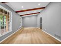 Bright living room featuring hardwood floors, exposed beams, and large windows at 4260 Bonaparte Dr, Tucker, GA 30084
