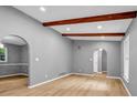 Spacious living room featuring hardwood floors, exposed beams, and arched doorways at 4260 Bonaparte Dr, Tucker, GA 30084