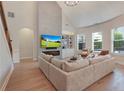 Bright living room with vaulted ceilings, fireplace, built-in shelving, and hardwood floors at 904 Urban Ash Ct, Johns Creek, GA 30022