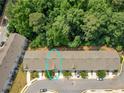 Aerial view of a townhome community backing up to a lush and mature tree line providing privacy at 3135 Journal Ct, Decatur, GA 30035