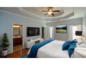 Spacious main bedroom boasts tray ceiling, hardwood floors, en-suite bath, and ample natural light at 6865 Cowan Mill Rd, Winston, GA 30187