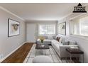 A staged living room offers a welcoming ambiance with hardwood floors and a sunlit window at 1561 Rupert Rd, Decatur, GA 30032