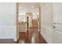 Bright entryway with hardwood floors, white wainscoting, and open view to kitchen and staircase at 2638 Lake Manor Cir, Duluth, GA 30096