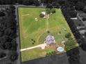 Aerial shot of the entire property, including a pool and multiple outbuildings at 3905 Pointer Rd, Loganville, GA 30052