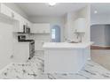 Modern kitchen featuring white cabinets, stainless steel appliances, and sleek countertops at 6118 Arbor Links Rd, Lithonia, GA 30058