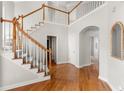 Spacious foyer showcasing hardwood floors, a staircase, and arched doorways for a grand entry at 1560 Heritage Trl, Roswell, GA 30075