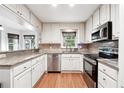 Well-lit kitchen featuring granite counters, stainless steel appliances, and white cabinetry at 3657 Linda Dr, Loganville, GA 30052