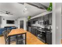 Modern kitchen with stainless steel appliances, black cabinetry, and an island with seating at 800 Peachtree Ne St # 8612, Atlanta, GA 30308
