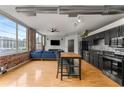 Open-concept living area showcases exposed brick, stainless steel appliances, and a modern kitchen island at 800 Peachtree Ne St # 8612, Atlanta, GA 30308