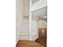Bright entryway features a staircase with white railing and hardwood floors leading to living spaces at 1278 Houndslake Dr, Marietta, GA 30008