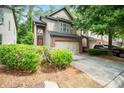 Charming townhome with a two-car garage, manicured bushes, and a well-maintained driveway at 1278 Houndslake Dr, Marietta, GA 30008
