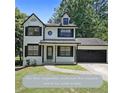 Charming two-story home with black trim, attached garage, and manicured lawn at 3087 Drexel Ln, Jonesboro, GA 30236