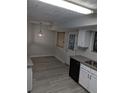 Eat-in kitchen with stainless sink, modern lighting, granite counters, and backyard door at 3087 Drexel Ln, Jonesboro, GA 30236