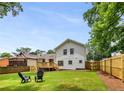 Expansive backyard featuring a deck, lush lawn, and a newly installed wooden fence at 2090 Rocky Mill Drive, Lawrenceville, GA 30044