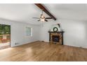 Bright living room features hardwood floors and a stone fireplace with decorative mantle at 2090 Rocky Mill Drive, Lawrenceville, GA 30044