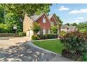 The exterior of the house showcases a two-car garage, basketball hoop, and well-kept lawn with landscaping at 660 Briarleigh Way, Woodstock, GA 30189