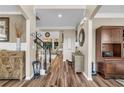Inviting foyer with hardwood floors, a staircase, and a view into the living room at 660 Briarleigh Way, Woodstock, GA 30189