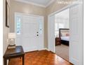 Inviting foyer with hardwood floors and a view to the staged bedroom at 1574 Glenfield Dr, Lawrenceville, GA 30043