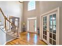 Grand foyer with hardwood floors, high ceilings and a large arched window at 1620 Silverleaf Way, Alpharetta, GA 30005