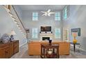 Bright living room with a fireplace, tall windows, and a view of the staircase at 1620 Silverleaf Way, Alpharetta, GA 30005