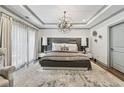 Luxurious main bedroom with tray ceilings, chandelier lighting, and modern accents at 1049 Brandsford Nw St # 27-01, Atlanta, GA 30318