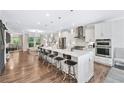 Spacious kitchen featuring a large island with seating and stainless steel appliances and open living space at 1049 Brandsford Nw St # 27-01, Atlanta, GA 30318