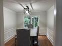 Dining room with natural lighting, gray upholstered chairs, and an elegant light fixture at 2181 Rodao Sw Dr, Lilburn, GA 30047