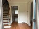 Inviting foyer with hardwood floors, paneled walls, staircase, and views into other rooms at 2181 Rodao Sw Dr, Lilburn, GA 30047