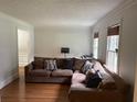 Spacious living room showcasing hardwood floors, neutral walls, and a comfortable sectional sofa at 2181 Rodao Sw Dr, Lilburn, GA 30047