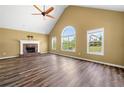 Spacious living room with vaulted ceilings, a fireplace, and large windows at 405 Maple Rdg, White, GA 30184