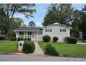 Charming home with an inviting front porch, manicured landscaping, and a well-kept lawn at 3835 Clearwater Dr, Atlanta, GA 30349