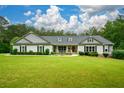 Well-maintained single-story home with a lush green lawn and covered front porch perfect for relaxing at 188 Macedonia Rd, White, GA 30184