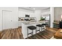 Bright modern kitchen features stainless appliances, granite counters, and island seating at 1911 Colestock Se Ave, Conyers, GA 30094