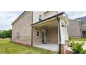 Back of house with brick siding, an entrance to the covered porch, and a green lawn at 1961 Ecoland Dr, Grayson, GA 30017