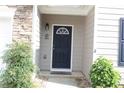 Inviting front entrance with a decorative door, stone walkway and trimmed shrubs at 414 Norton Xing, Woodstock, GA 30188