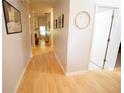 Light-filled hallway showcasing hardwood floors and decorative wall art at 414 Norton Xing, Woodstock, GA 30188